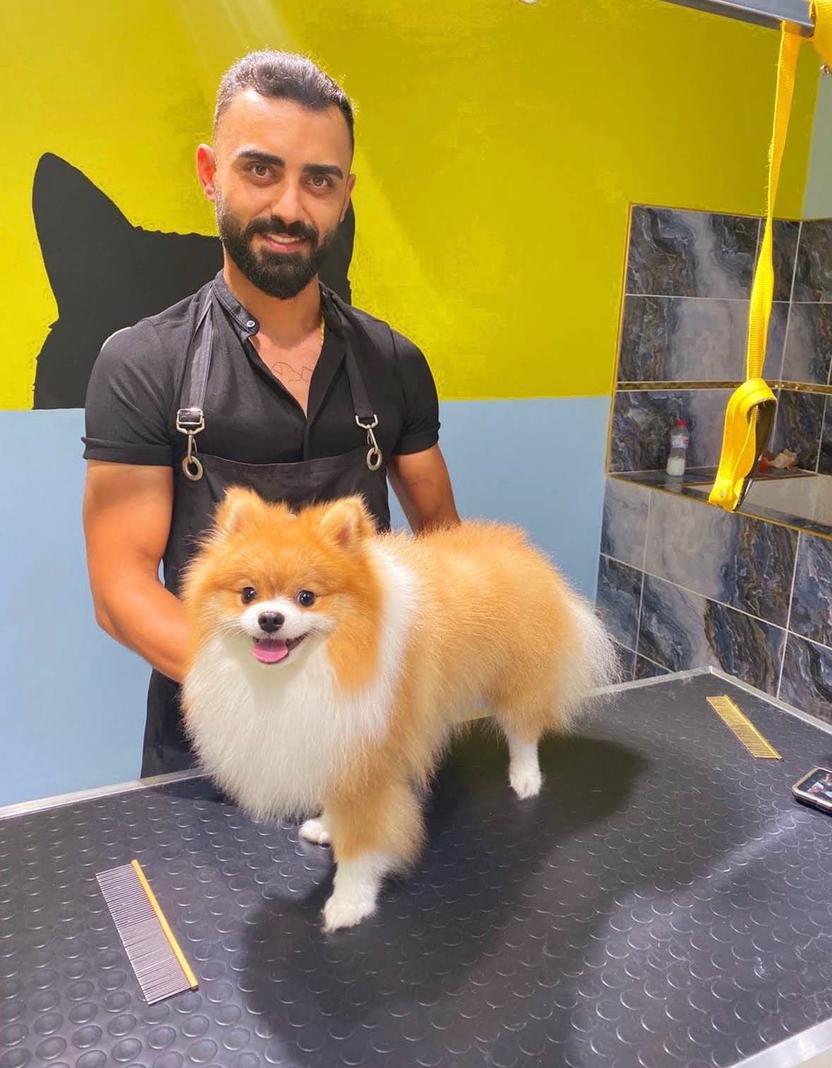 Faik Kopuz, owner and groomer at Patim Pet Kuaför, with a freshly groomed Pomeranian